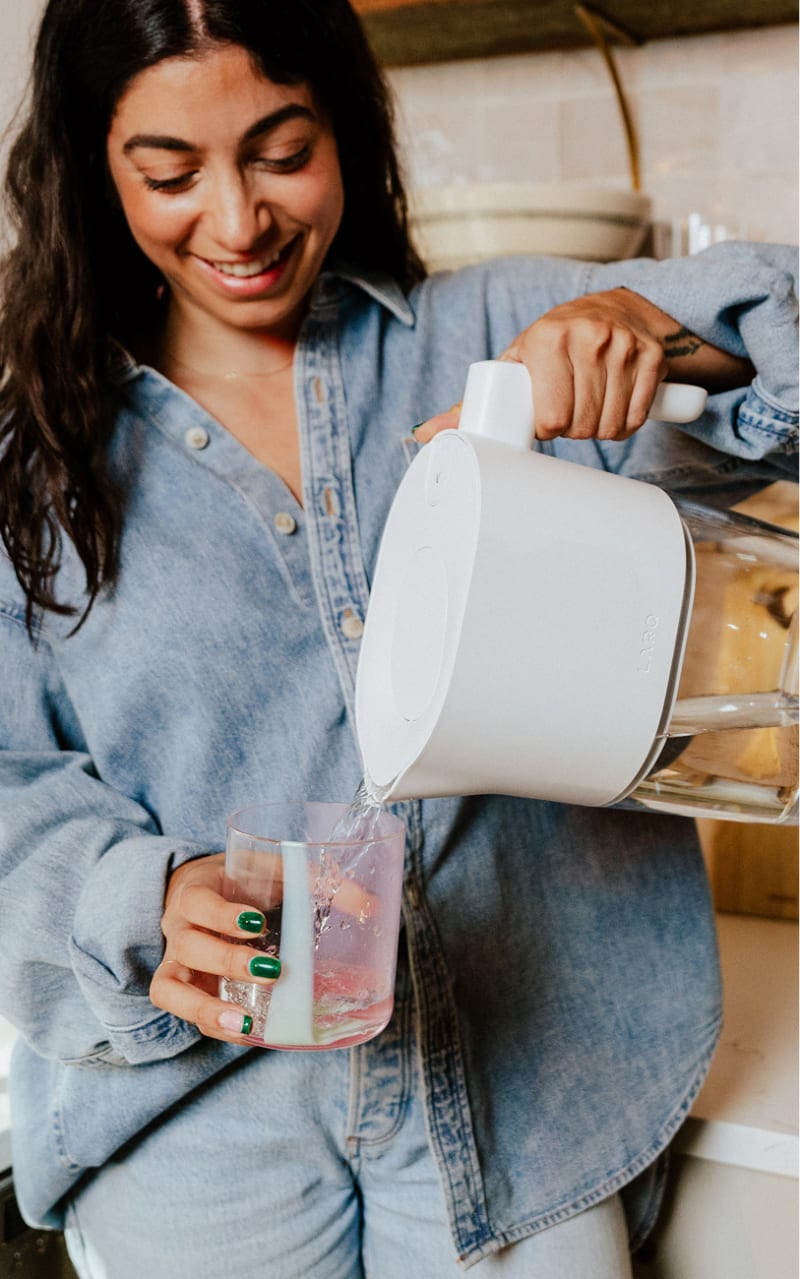 LARQ Pitcher PureVis Lite - woman pouring water into a glass