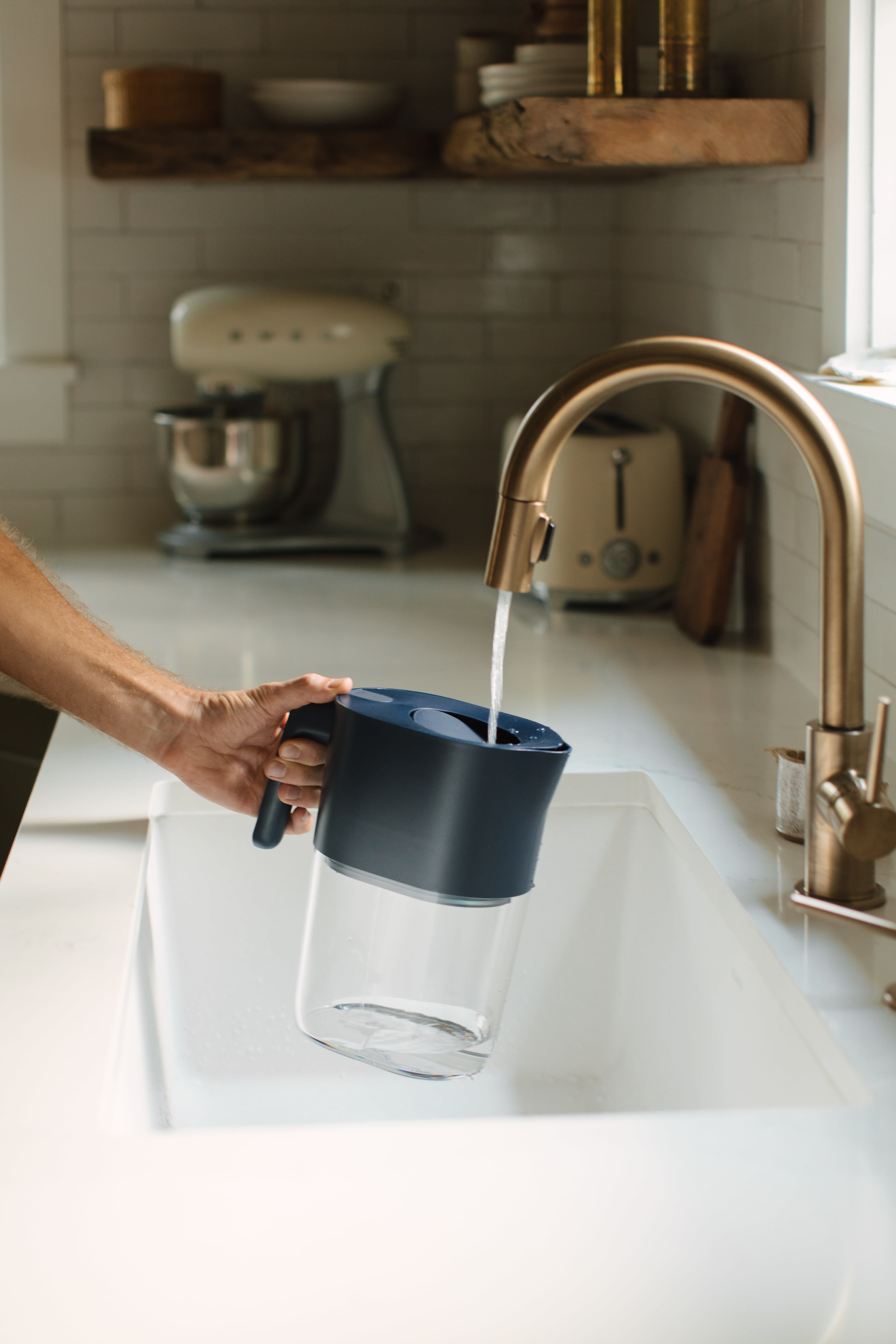 LARQ Pitcher PureVis in Monaco Blue filling up from the tap 