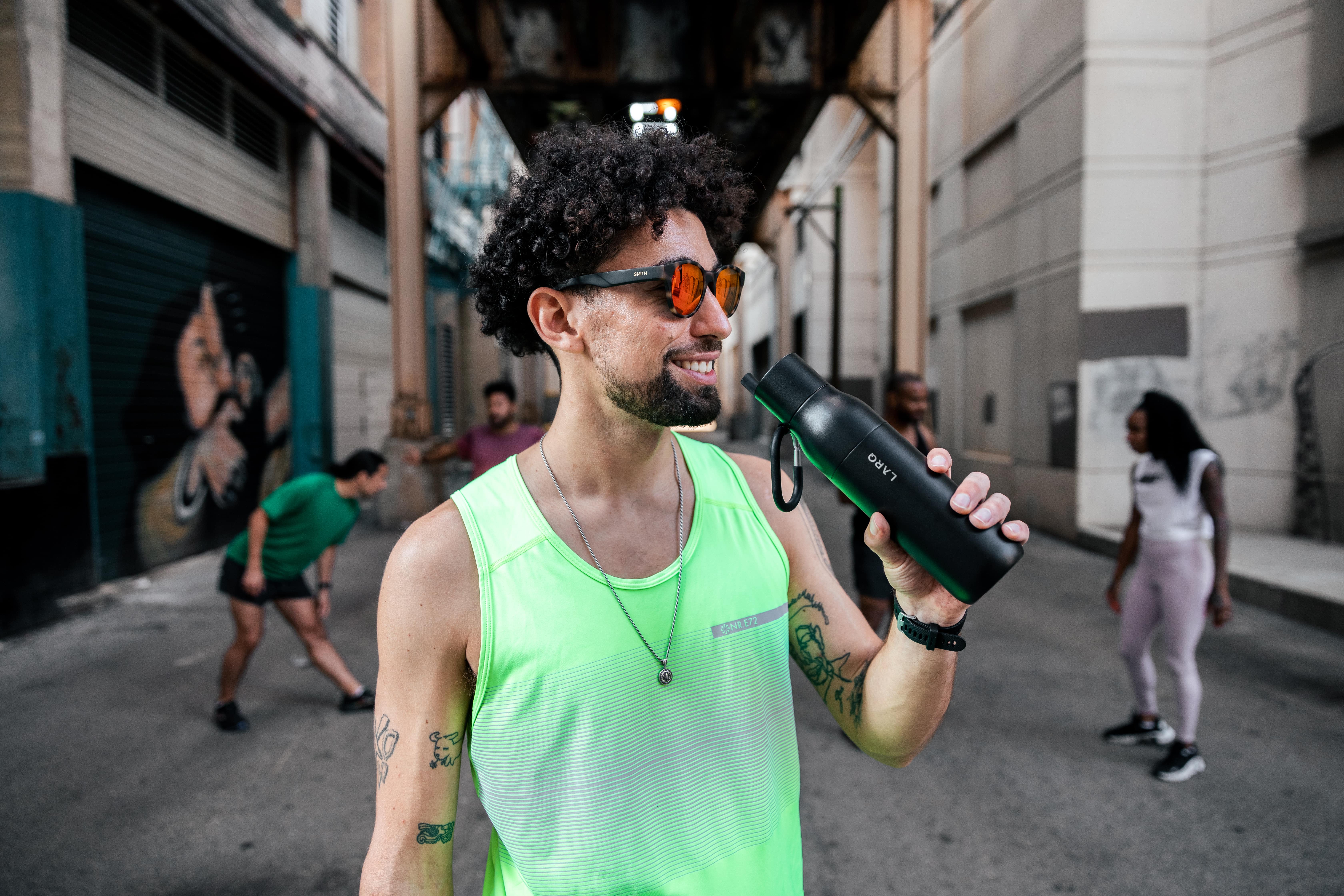 Man drinking from LARQ Bottle Filtered in Obisidian black