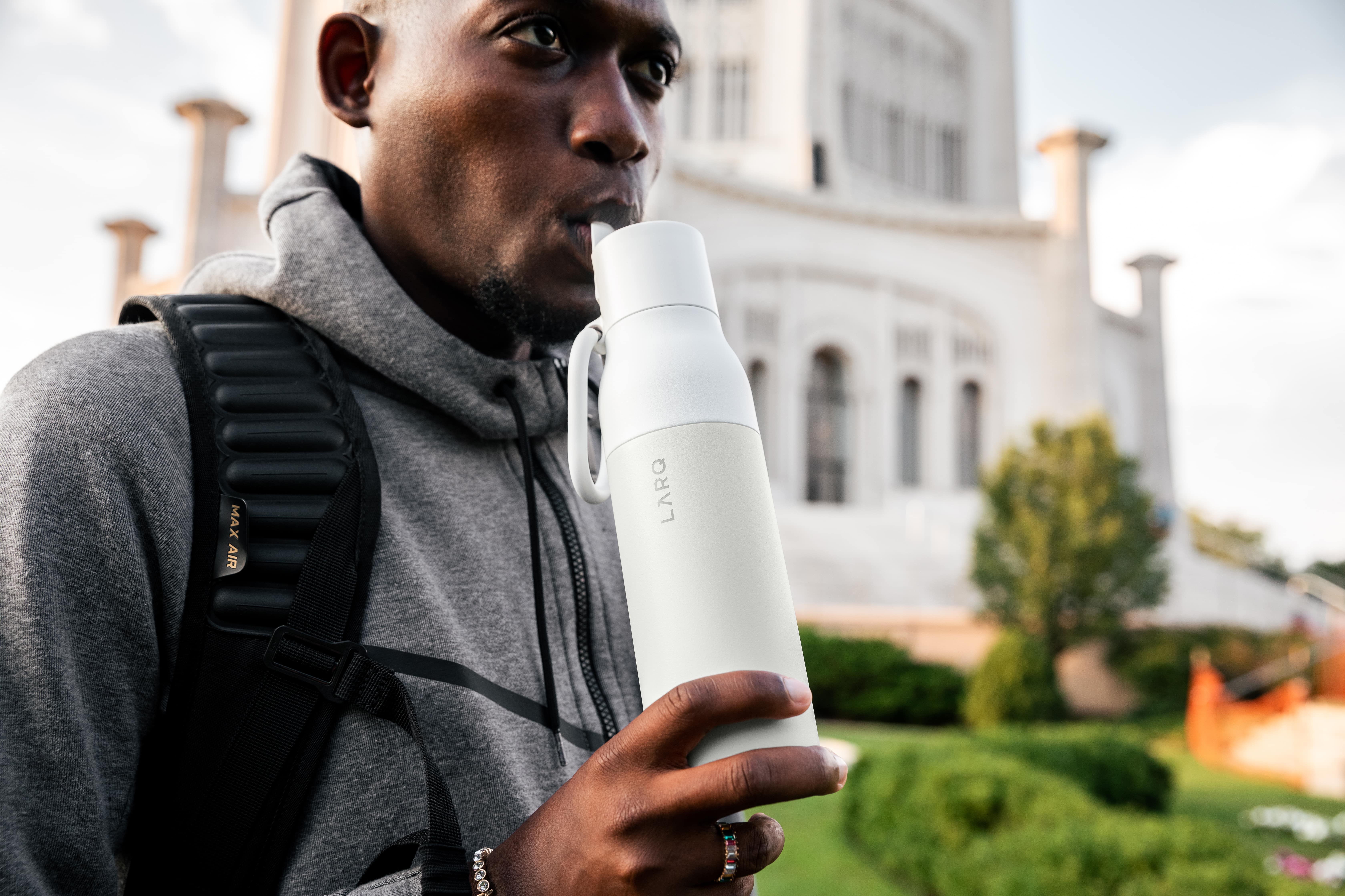 Man drinking from the LARQ Bottle Filtered in Granite White