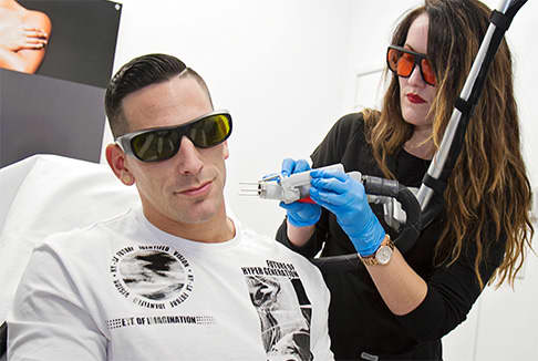 Man removing tattoo from his neck with laser tattoo removal