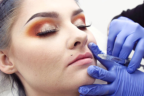 Dark-haired woman receiving Xeomin procedure