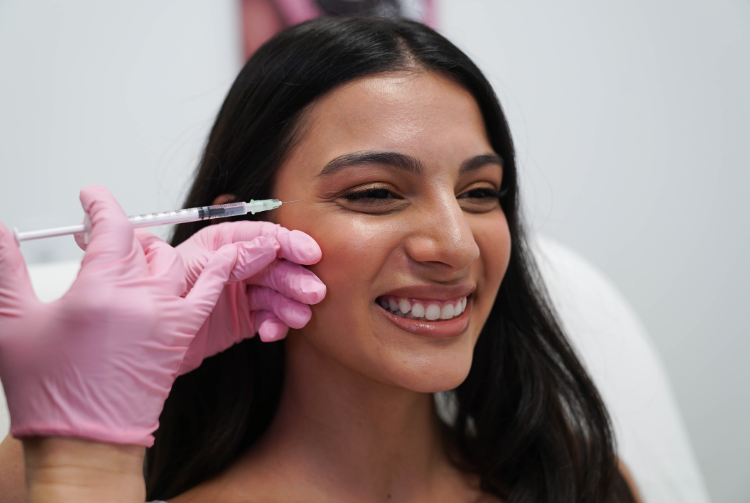 Dark-haired woman receiving Xeomin procedure