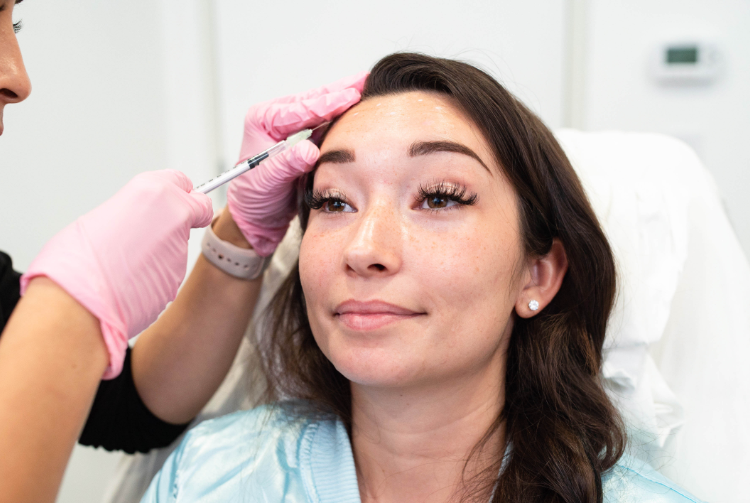 Dark-haired woman receiving Xeomin procedure