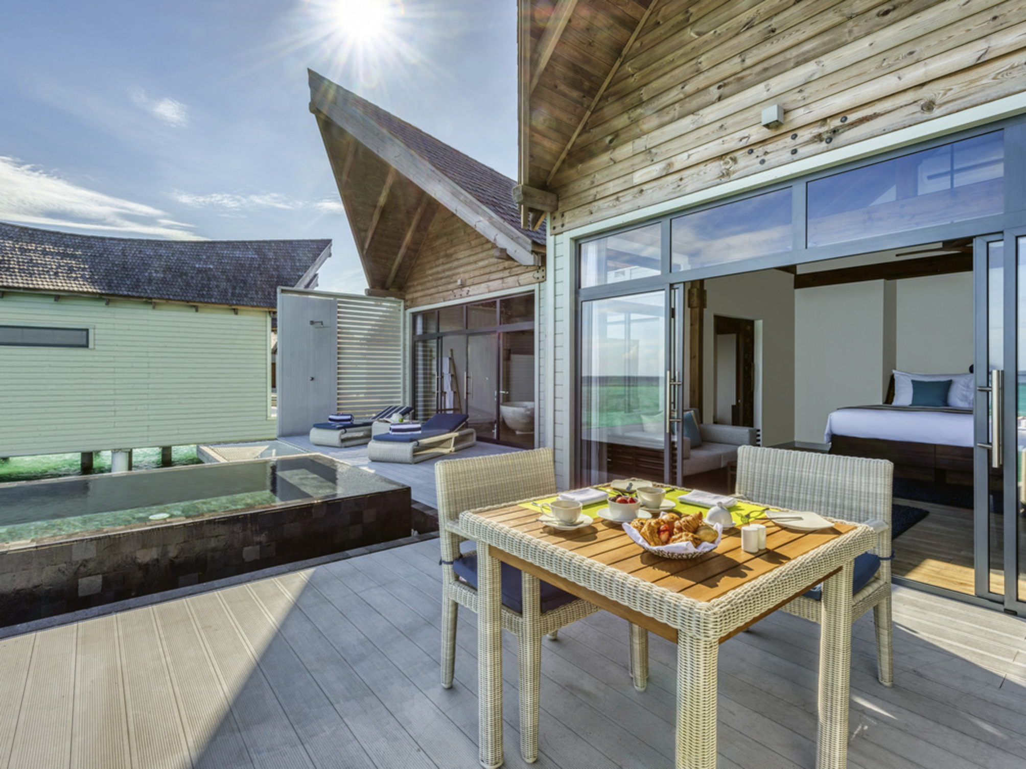 Overwater pool villa ocean sunrise view