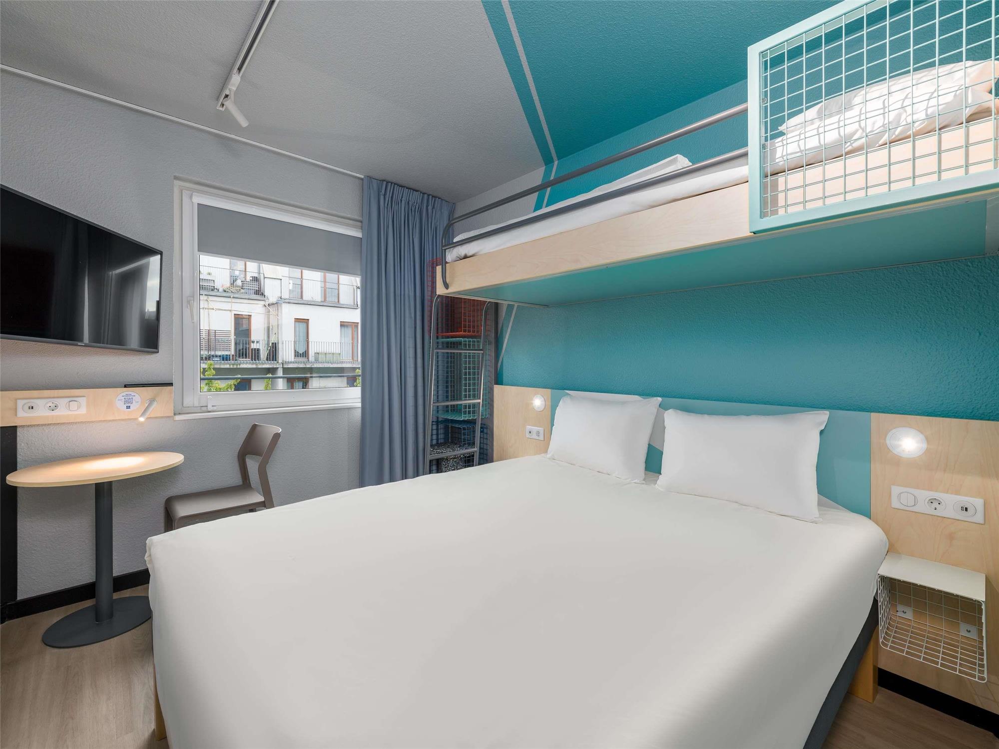 Standard room with a double bed and a loft bed