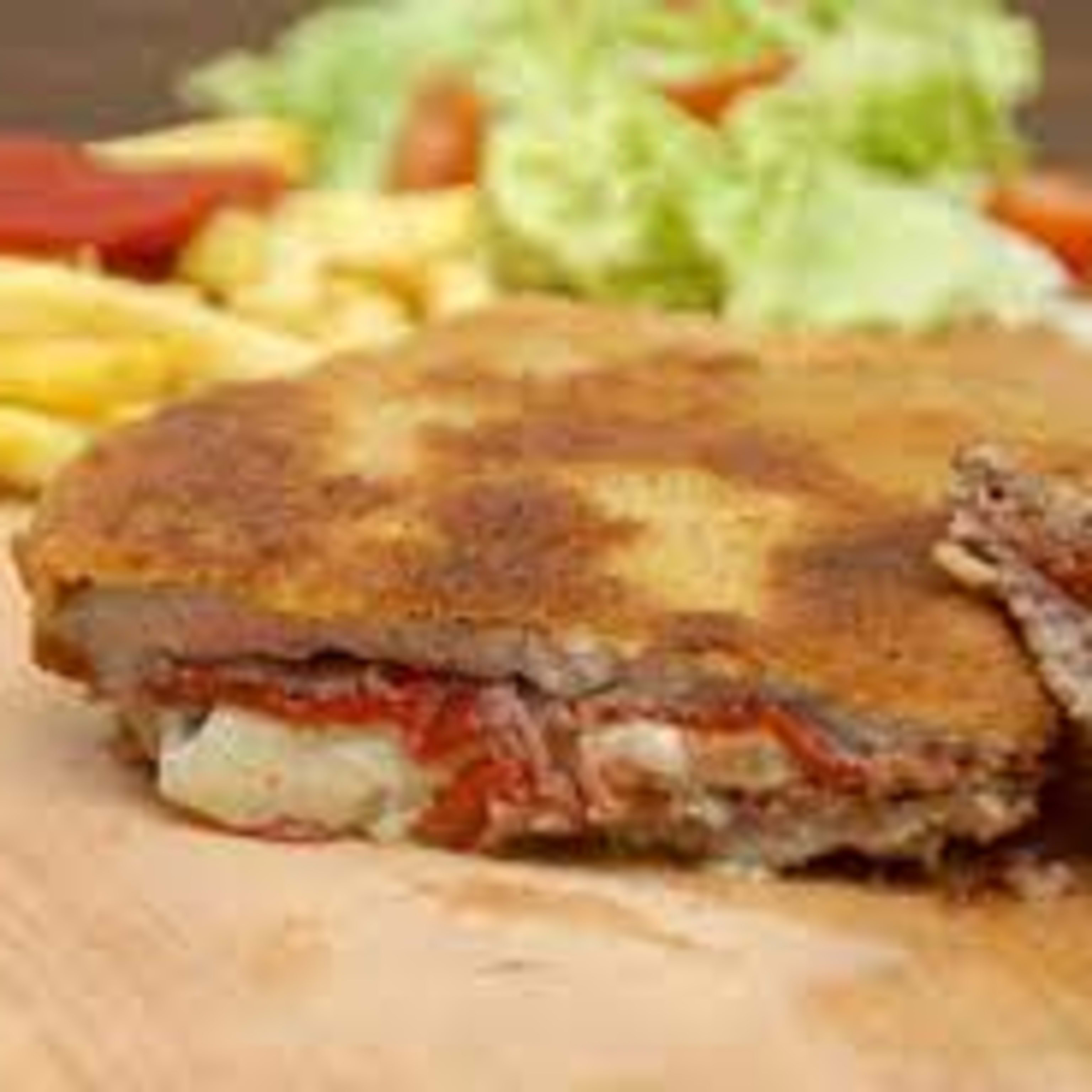 Cachopo de ternera, jamón serrano y queso gouda más ensalada, pimientos padron y patatas