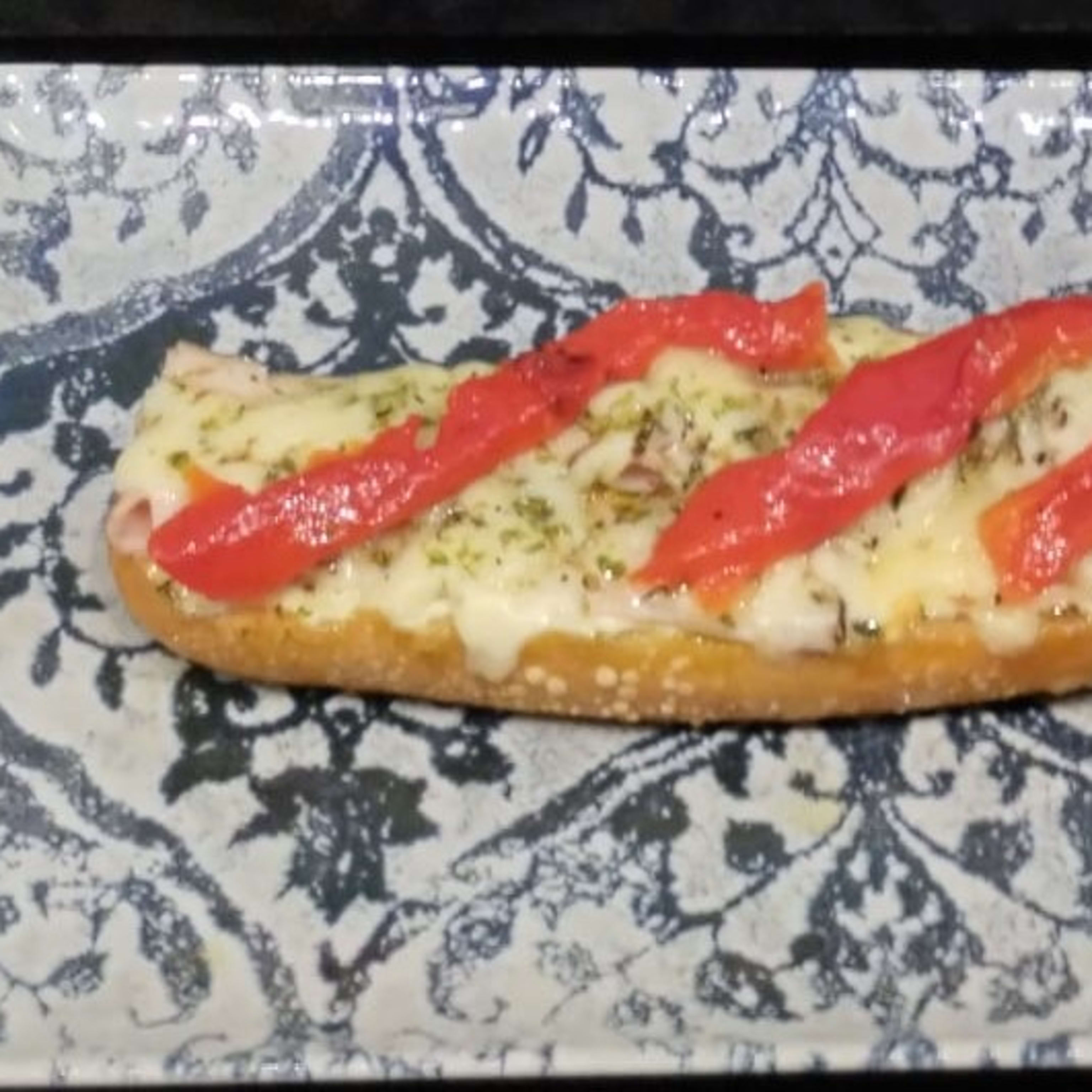 • ROAST PORK LOIN WITH ROASTED RED PEPPERS AND MELTED SOFT CHEESE