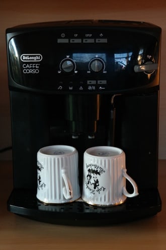 DeLonghi coffee maker with two mugs laying upside down - could be used for the internet of things