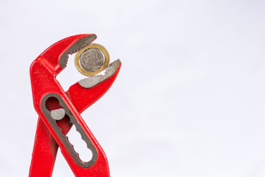 Pliers squeezing a Greek Euro coin Greek haircut claim is exempt from Brussels I, CJEU advocate general says