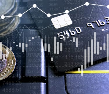 credit card next to one pound coins