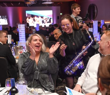 Guests enjoying entertainment at a table