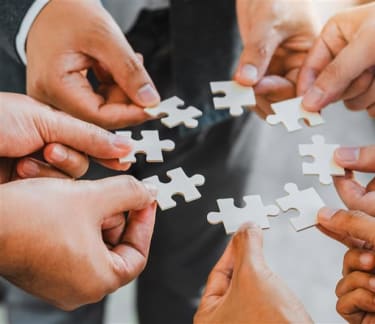 Hands holding a piece of jigsaw