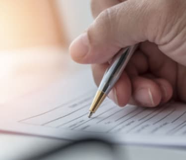 Person writing on a document