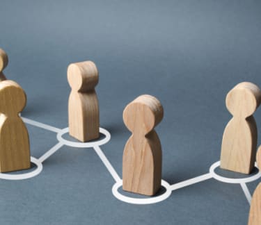 Wooden figurines of people connected