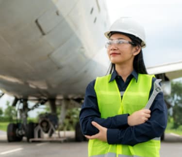 Woman working next to a plane