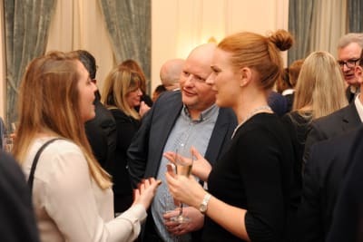 Three people talking at a LCI Networking event