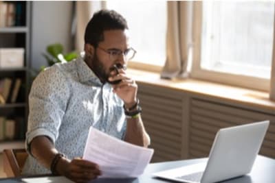 man looking at a laptop