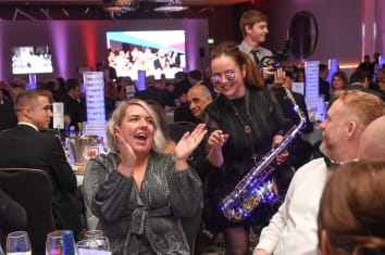 Guests enjoying entertainment at a table