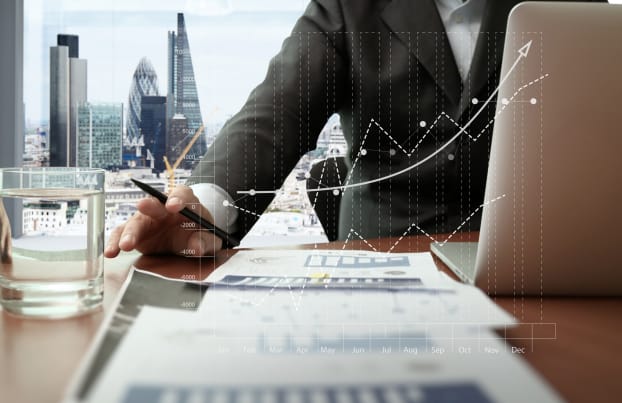 Man working with graphs and London City in the background