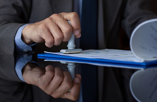 Man stamping a document