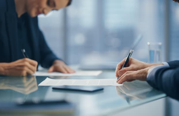 Two professionals signing a contract