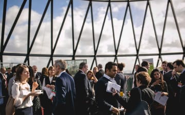 People networking at the Gherkin building