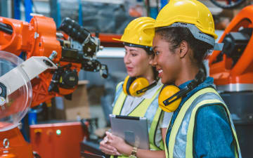 Two women working in a factory