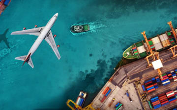 Plane flying on top of a post, showing ships and containers