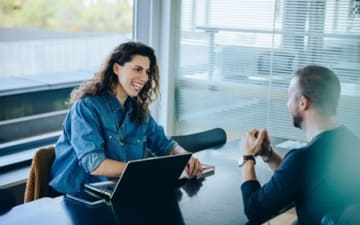 Woman and man talking in a meeting