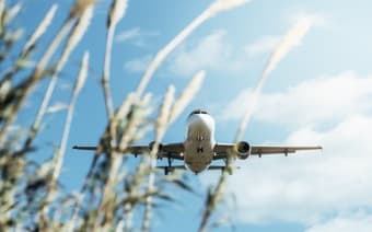 a plane flying above a field
