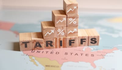 Wooden blocks spelling out 'tariffs', symbolizing the impact of economic policies on trade