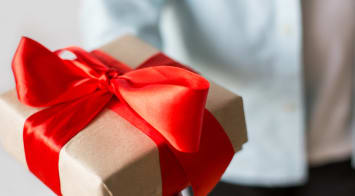 Box wrapped with a red ribbon