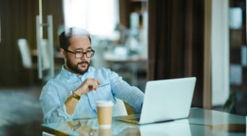 Businessman looking at his laptop