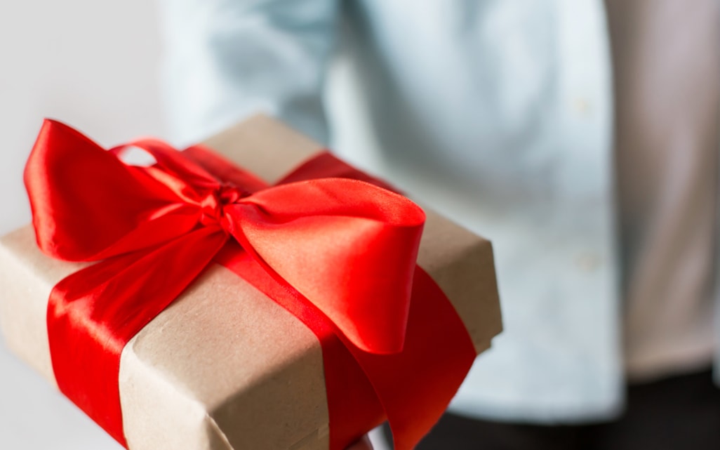 Box wrapped with a red ribbon