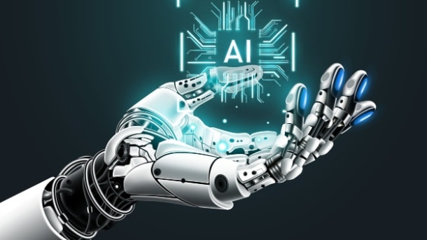 Robotic hand holding a the word AI
