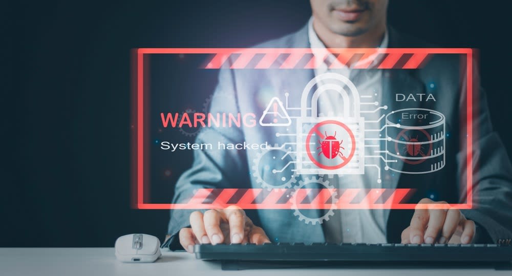 Person on a PC looking at a warning alert