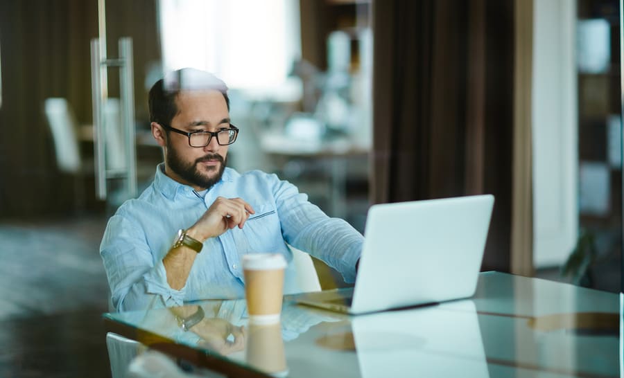 Businessman looking at his laptop