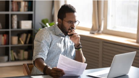 man looking at a laptop