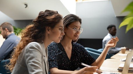 Two women working together