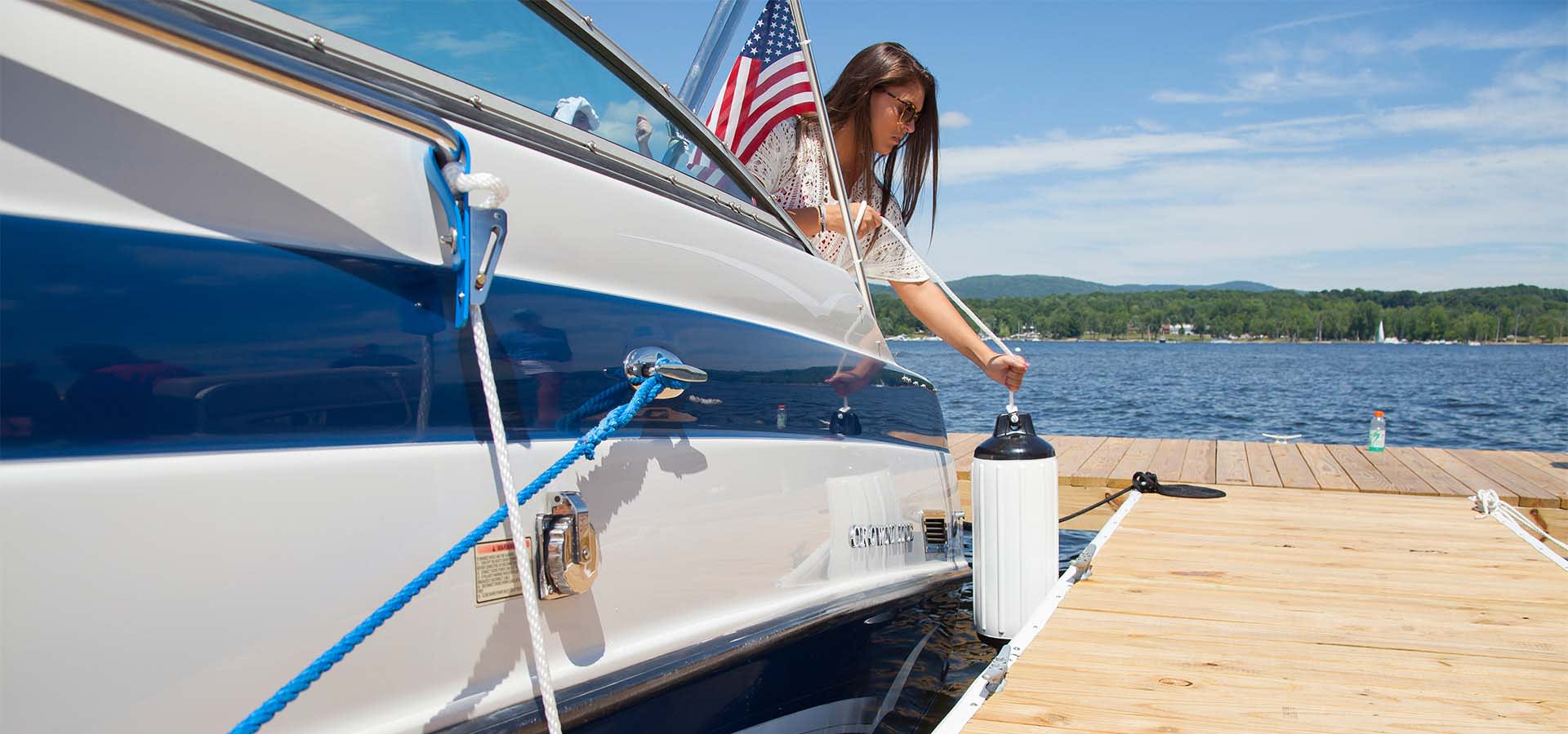 Woman Hanging a Boat Fender while Docking