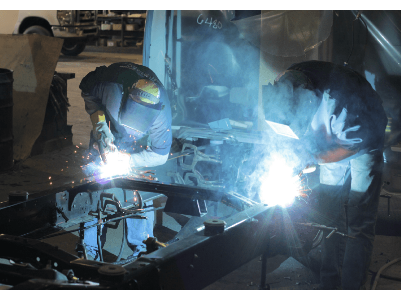 Trailer Chassis Being Welded by Two People During the Chassis Manufacturing Process