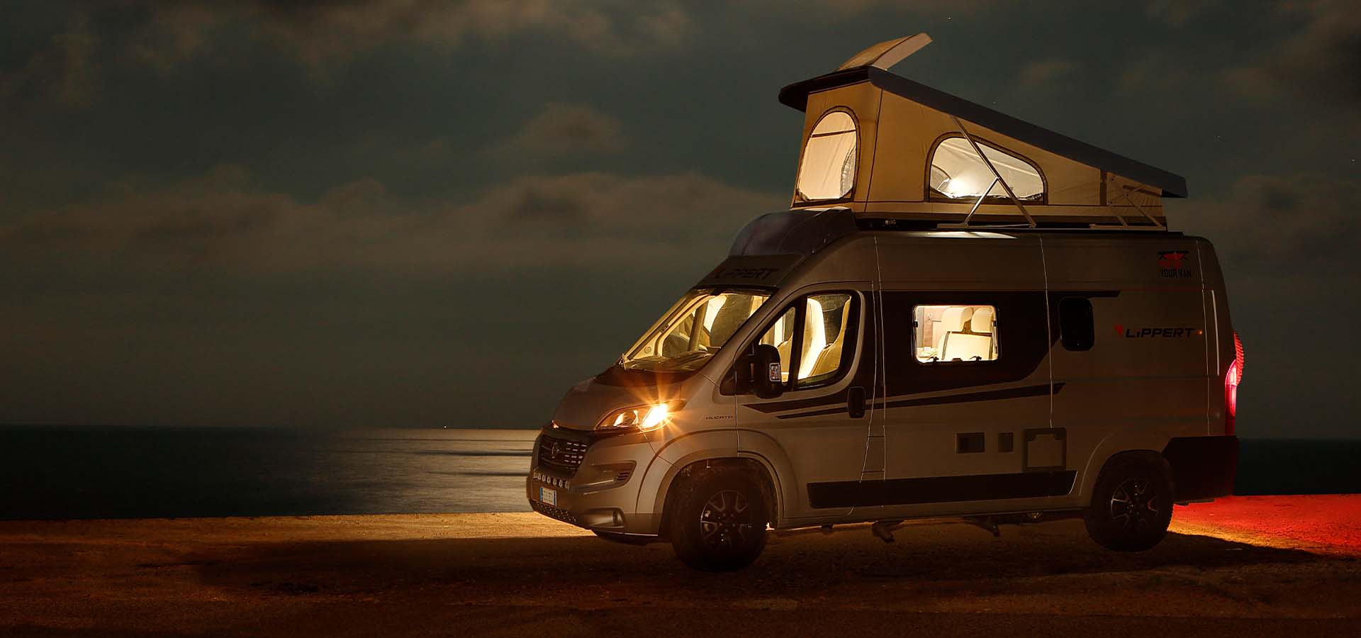 Class B van parked on the road at night