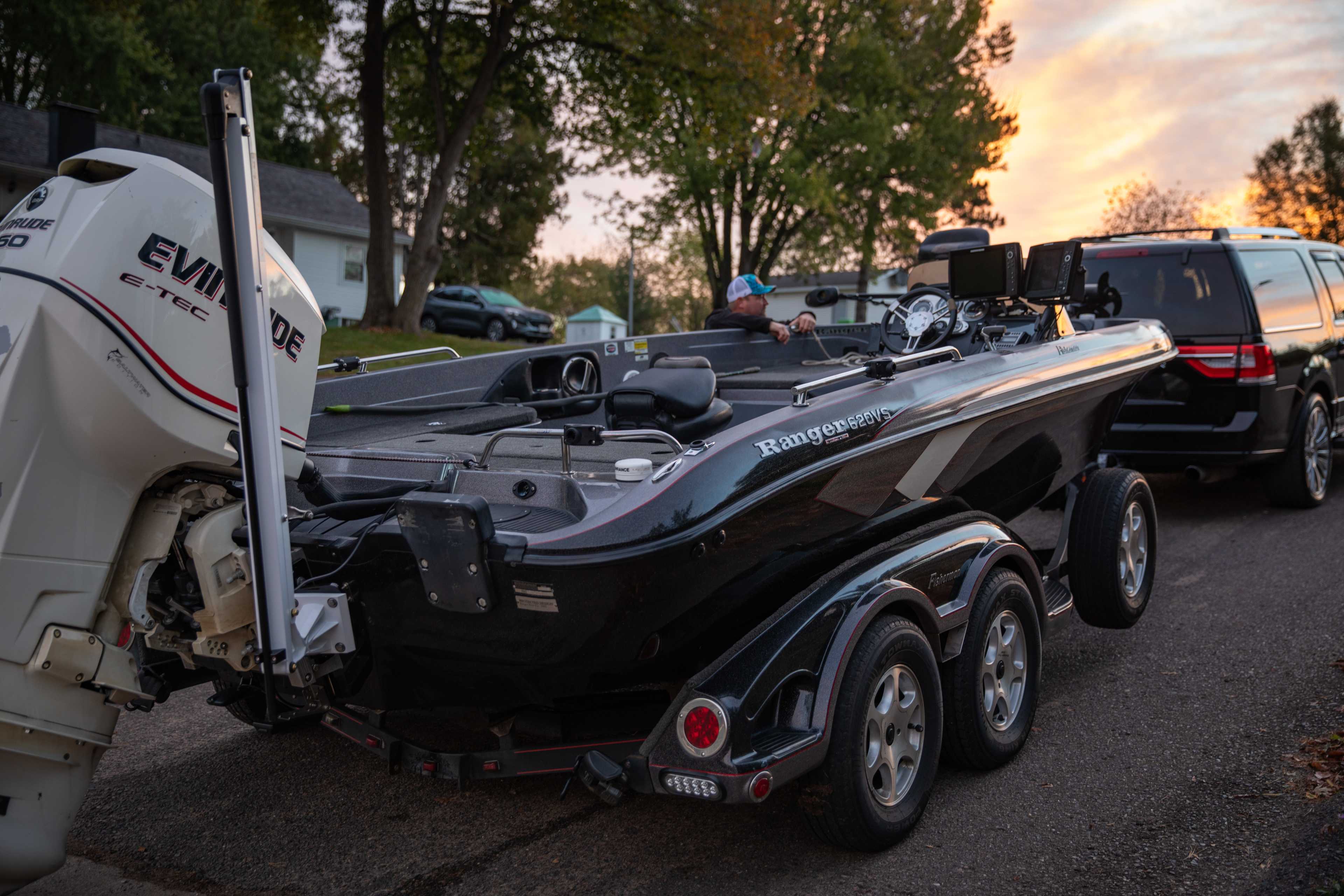 Close-up of Lewmar Axis 6 electric shallow water anchor motor housing and pole on bass boat transom at sunset