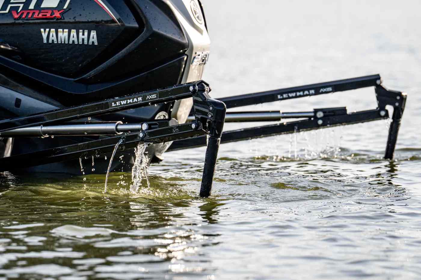 Lewmar Axis shallow water anchor legs deployed off the transom of a Yamaha VMAX bass boat, water dripping as the anchor plants