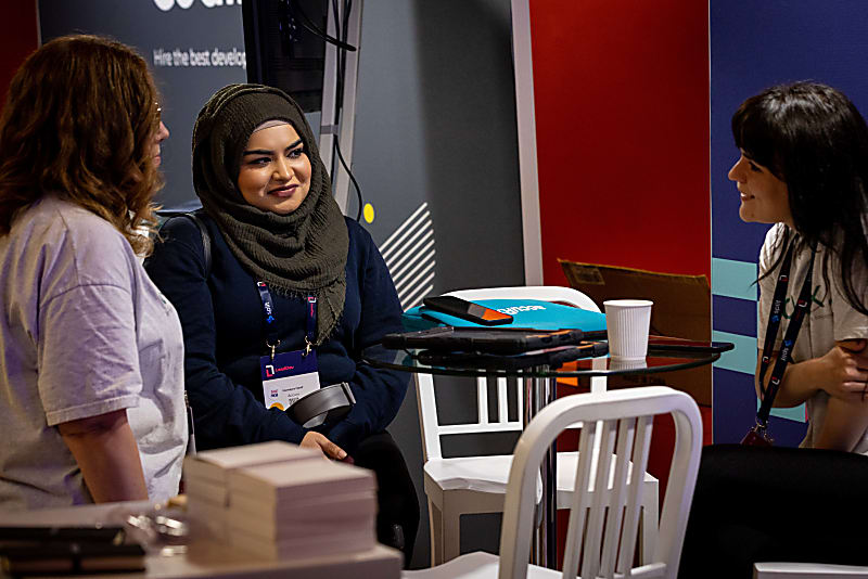 A speaker at LeadDev London, speaking with audience members in offfice hours