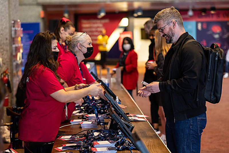 Masked staff at the registration desk for LeadDev London 2022