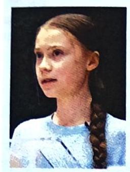 A young woman with braided hair and a light blue sweater is pictured from the shoulders up, looking to the side against a dark background.