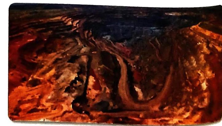 An abstract painting with swirling textures in shades of dark brown, orange, and red, suggesting a rough, layered landscape or geological formation under dramatic lighting.