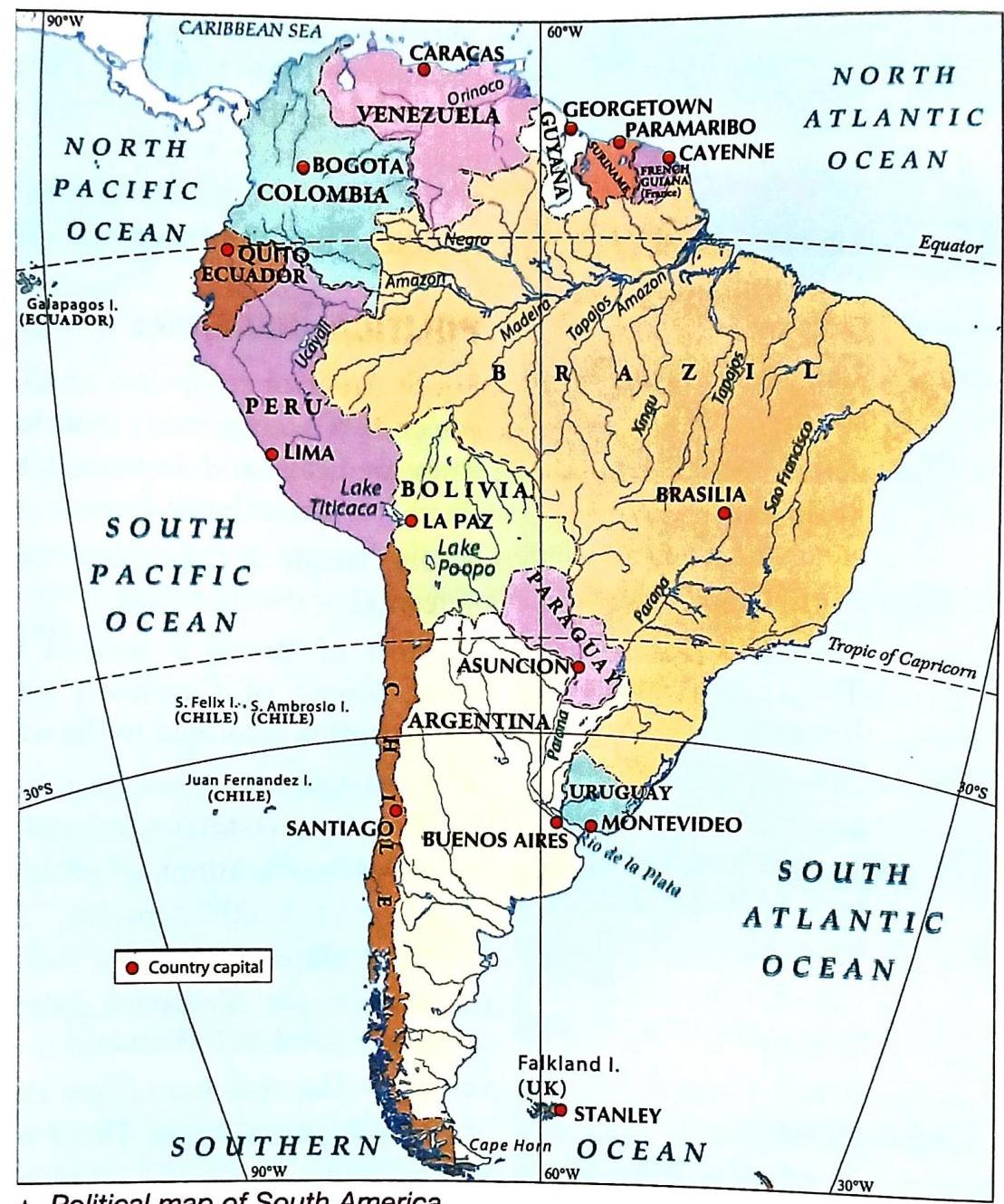 A political map of South America showing country borders, capitals marked with red dots, and surrounding oceans. Major countries like Brazil, Argentina, Peru, Colombia, and Venezuela are visible, along with their respective capitals such as Brasilia, Buenos Aires, Lima, Bogota, and Caracas. Key geographical features include the Pacific and Atlantic Oceans, the Caribbean Sea, the Amazon River system, Lake Titicaca, and Lake Poopó. The Equator and the Tropic of Capricorn are indicated, as well as latitude and longitude lines. Islands like the Galapagos, Juan Fernandez, and Falkland Islands are also labeled.